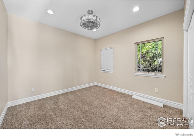 spare room with carpet floors, baseboards, and recessed lighting