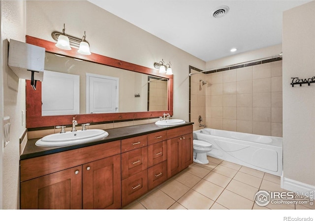 full bathroom featuring tile patterned flooring, tub / shower combination, double vanity, and toilet