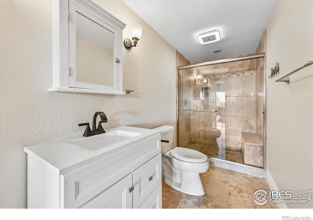 full bath with a shower stall, vanity, and toilet