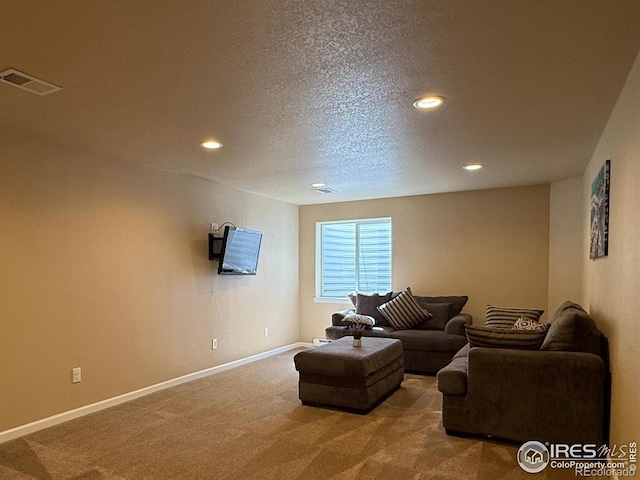 living area with carpet, recessed lighting, baseboards, and a textured ceiling