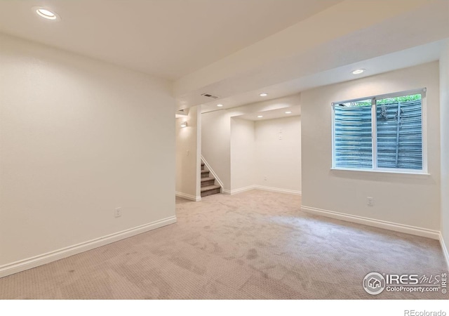 below grade area featuring carpet floors, stairway, recessed lighting, and baseboards