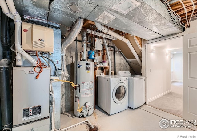 washroom with water heater, independent washer and dryer, and heating unit