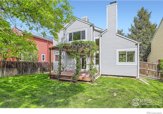 back of house featuring a wooden deck and a chimney