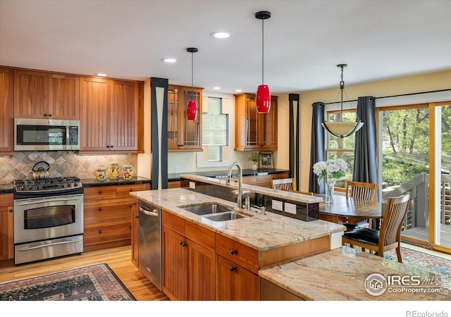5523 Stonewall Pl, Boulder, CO 80303 - kitchen featuring stainless steel appliances, a sink, light wood-type flooring, brown cabinetry, and recessed lighting