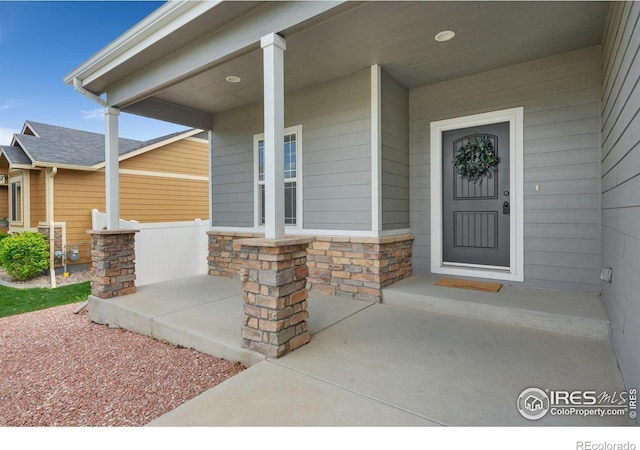 3933 Mount Hope St, Wellington, CO 80549 - doorway to property featuring a porch and stone siding