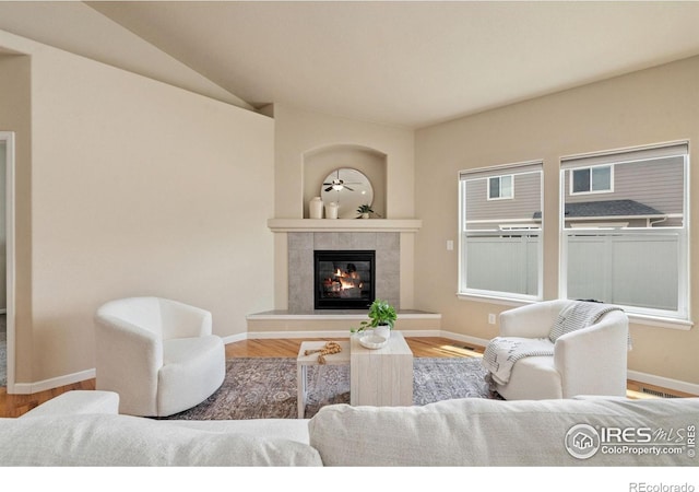 3933 Mount Hope St, Wellington, CO 80549 - living room with a tile fireplace, baseboards, and wood finished floors