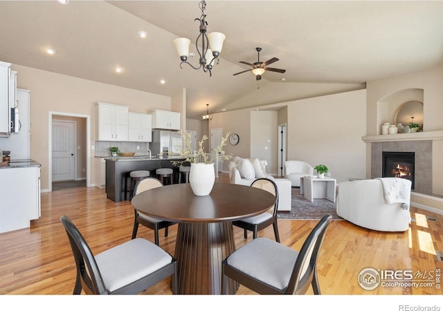 3933 Mount Hope St, Wellington, CO 80549 - dining space with ceiling fan, lofted ceiling, light wood-style floors, a fireplace, and recessed lighting