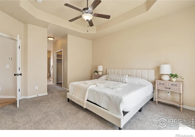 3933 Mount Hope St, Wellington, CO 80549 - bedroom featuring carpet flooring, a raised ceiling, baseboards, ceiling fan, and a spacious closet