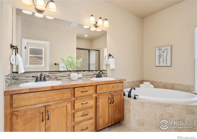 3933 Mount Hope St, Wellington, CO 80549 - full bath with a stall shower, a garden tub, double vanity, and backsplash