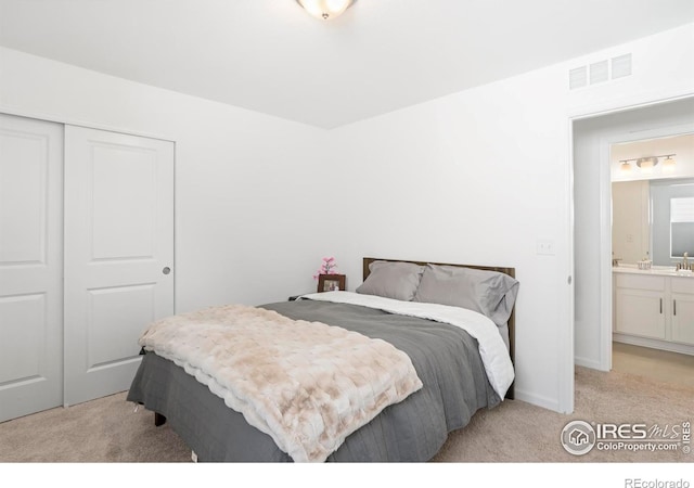 bedroom featuring light colored carpet and a closet