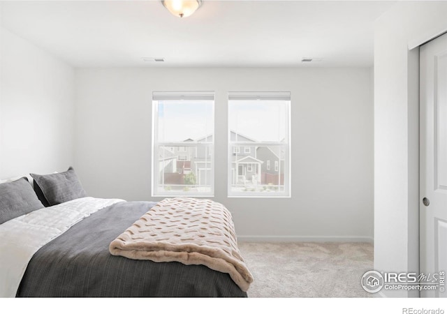 carpeted bedroom with baseboards