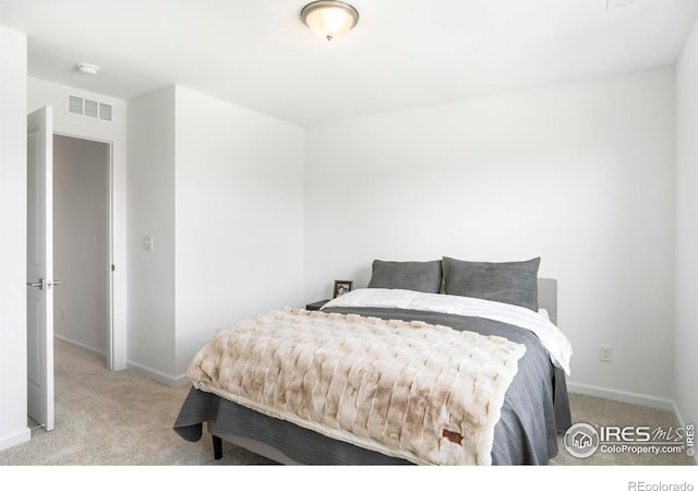 carpeted bedroom featuring baseboards