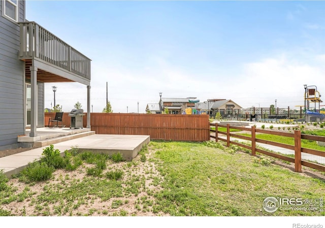 view of yard featuring a balcony and a patio