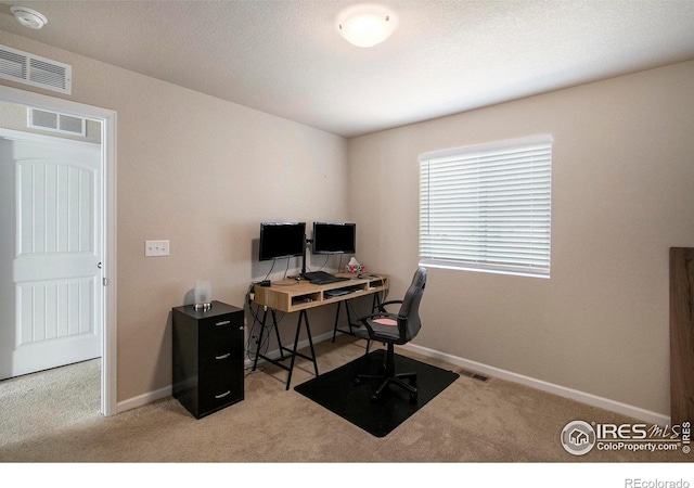 carpeted office featuring baseboards