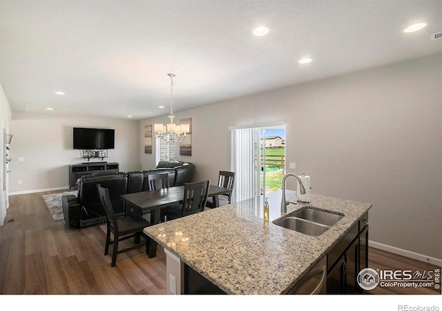 kitchen with a sink, dark wood-style floors, baseboards, and recessed lighting