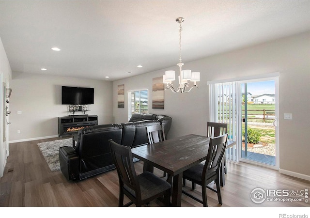 dining area with wood finished floors, a chandelier, recessed lighting, and baseboards