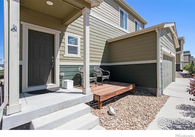 entrance to property with a garage and concrete driveway