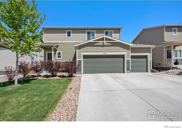 view of front of property with an attached garage, concrete driveway, and a front yard