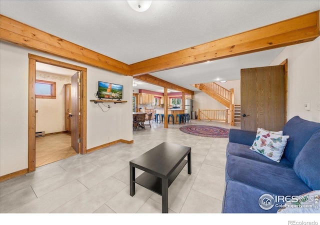 457 Spruce Mountain Dr, Drake, CO 80515 - living area with stairway, baseboards, beam ceiling, baseboard heating, and light tile patterned flooring