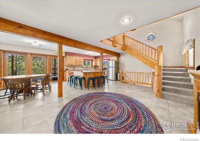 457 Spruce Mountain Dr, Drake, CO 80515 - dining room with healthy amount of natural light, light tile patterned floors, and stairs