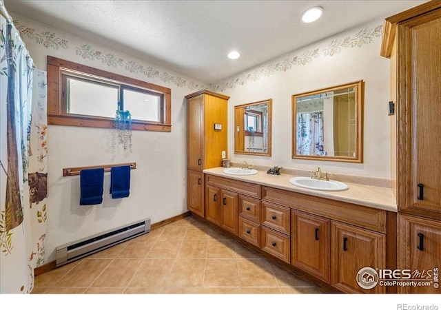 457 Spruce Mountain Dr, Drake, CO 80515 - full bath featuring baseboard heating, double vanity, tile patterned floors, recessed lighting, and baseboards