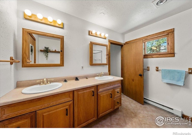 457 Spruce Mountain Dr, Drake, CO 80515 - full bath featuring baseboard heating, double vanity, tile patterned floors, and a textured ceiling