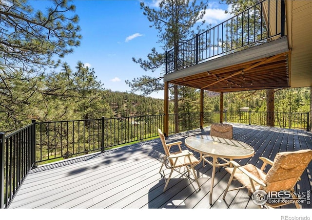 457 Spruce Mountain Dr, Drake, CO 80515 - wooden deck with a forest view and outdoor dining area