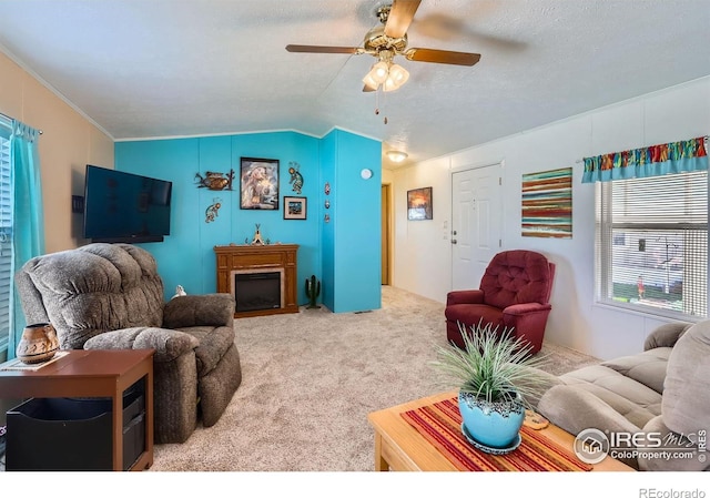 living area featuring carpet flooring, a ceiling fan, and lofted ceiling