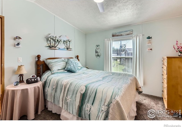 carpeted bedroom with vaulted ceiling, a textured ceiling, ornamental molding, and a ceiling fan