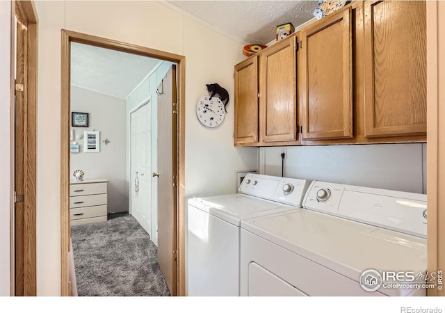 laundry room featuring cabinet space, washing machine and dryer, ornamental molding, a textured ceiling, and carpet flooring