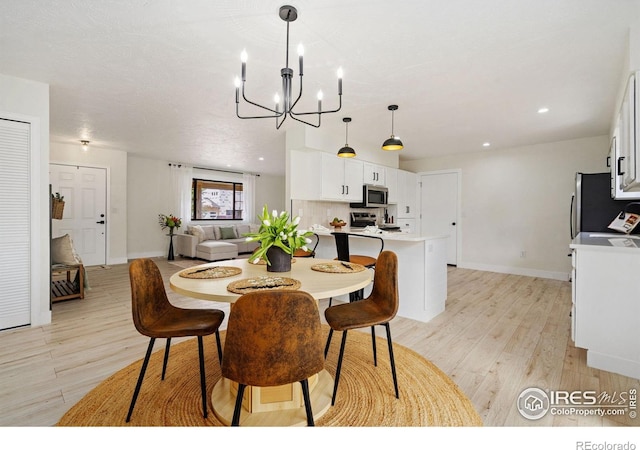 dining room with light wood-type flooring, a chandelier, baseboards, and recessed lighting