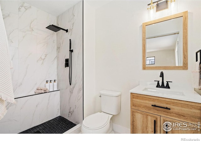bathroom with a marble finish shower, toilet, and vanity