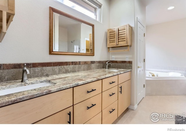 full bathroom featuring double vanity, tile patterned floors, and a bath