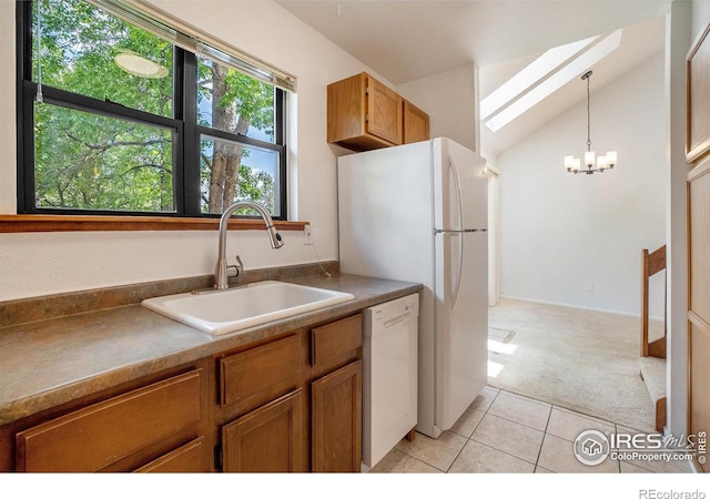 2066 Weathertop Ln, Fort Collins, CO 80526 - kitchen featuring white appliances, a sink, light carpet, brown cabinets, and vaulted ceiling