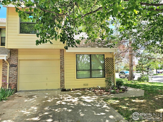 2066 Weathertop Ln, Fort Collins, CO 80526 - view of front of property featuring brick siding, a garage, and concrete driveway