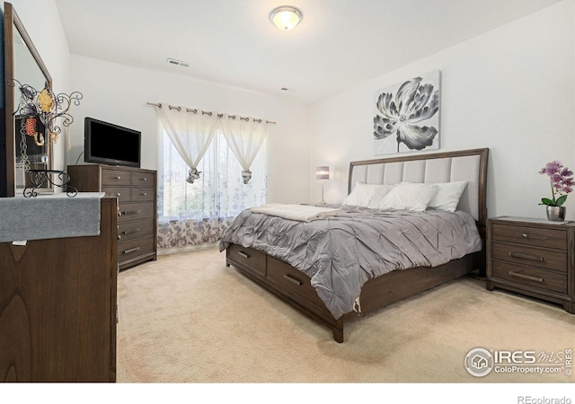 bedroom featuring light carpet