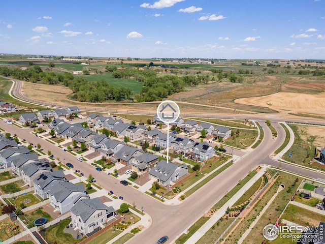 aerial view of property and surrounding area with nearby suburban area