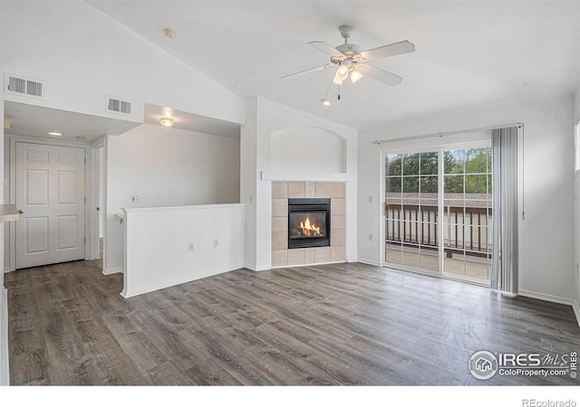3002 W Elizabeth St Unit G, Fort Collins, CO 80521 - unfurnished living room with vaulted ceiling, ceiling fan, wood finished floors, a tiled fireplace, and baseboards