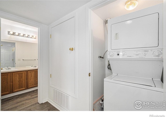 3002 W Elizabeth St Unit G, Fort Collins, CO 80521 - washroom featuring stacked washer / drying machine and wood finished floors