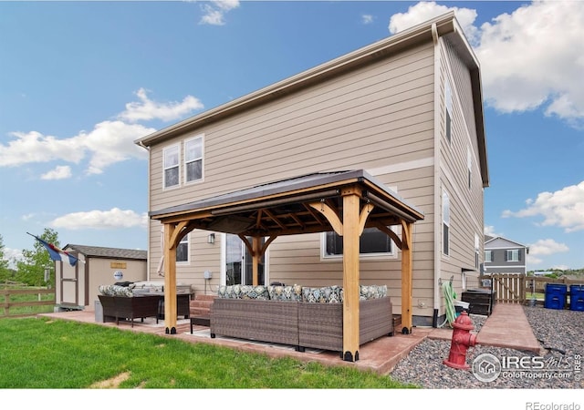 back of house featuring an outdoor hangout area, a gazebo, a patio area, and fence