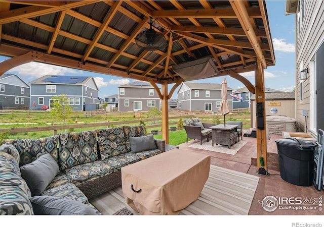 deck with outdoor lounge area, a residential view, a patio, fence, and a gazebo