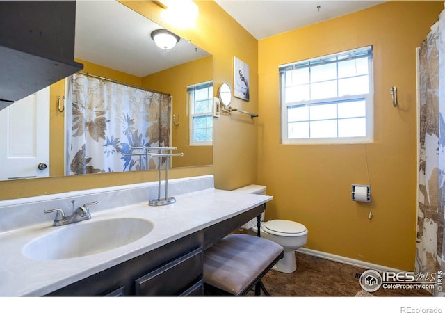 2229 S Elkhart St, Aurora, CO 80014 - full bathroom with toilet, vanity, and baseboards