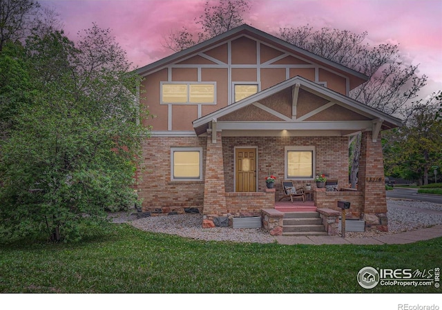 3116 47th St, Boulder, CO 80301 - view of front of house with a porch, a front lawn, brick siding, and stucco siding