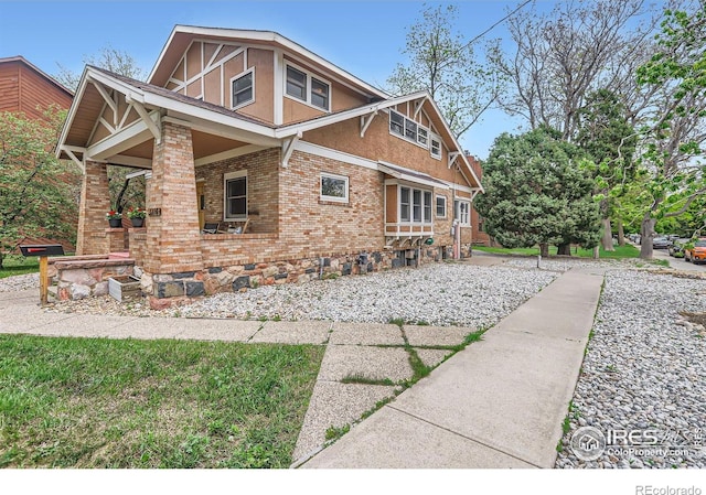 3116 47th St, Boulder, CO 80301 - view of side of home with brick siding, a porch, and stucco siding