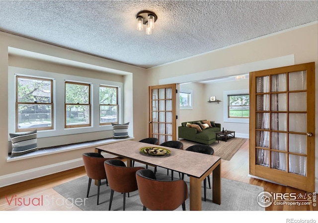 3116 47th St, Boulder, CO 80301 - dining room with a textured ceiling, wood finished floors, and baseboards