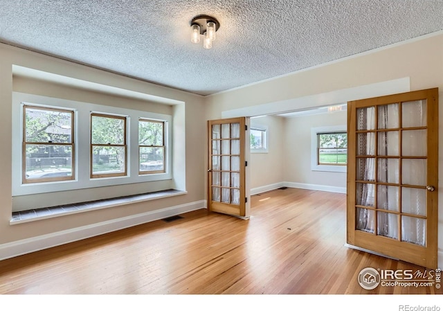 3116 47th St, Boulder, CO 80301 - spare room featuring a textured ceiling, light wood-style floors, and baseboards