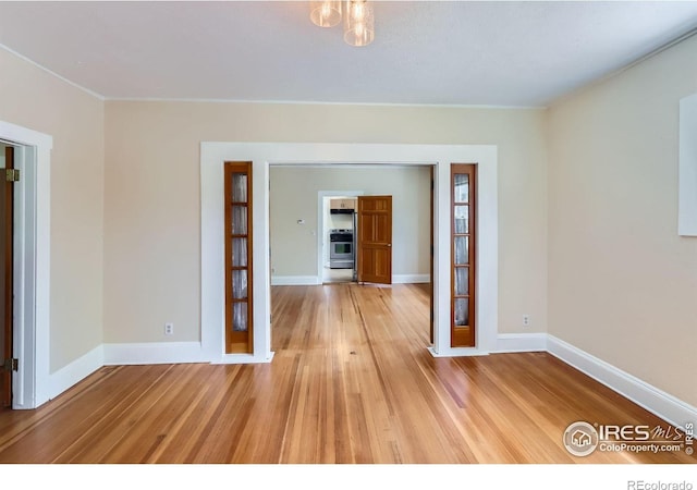 3116 47th St, Boulder, CO 80301 - unfurnished room with light wood finished floors, baseboards, and crown molding