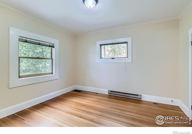 3116 47th St, Boulder, CO 80301 - spare room with a baseboard heating unit, light wood-style floors, crown molding, and baseboards