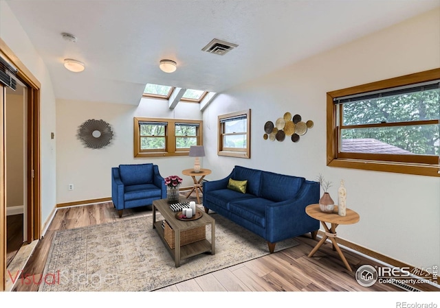 3116 47th St, Boulder, CO 80301 - living room with a skylight, wood finished floors, plenty of natural light, baseboards, and vaulted ceiling