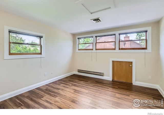 3116 47th St, Boulder, CO 80301 - spare room with a baseboard heating unit, wood finished floors, attic access, and baseboards